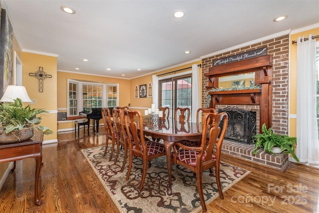 3060 Texs Fish Camp Rd, Connelly Springs, NC 28612 - dining space featuring ornamental molding, wood finished floors, recessed lighting, healthy amount of natural light, and a brick fireplace
