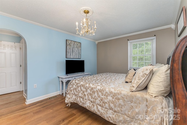 3060 Texs Fish Camp Rd, Connelly Springs, NC 28612 - bedroom featuring wood finished floors, ornamental molding, a chandelier, arched walkways, and a textured ceiling