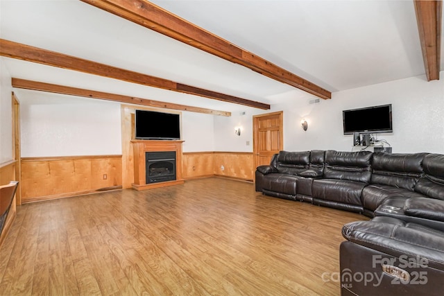 3060 Texs Fish Camp Rd, Connelly Springs, NC 28612 - living area with wainscoting, beamed ceiling, light wood-type flooring, a fireplace, and wood walls