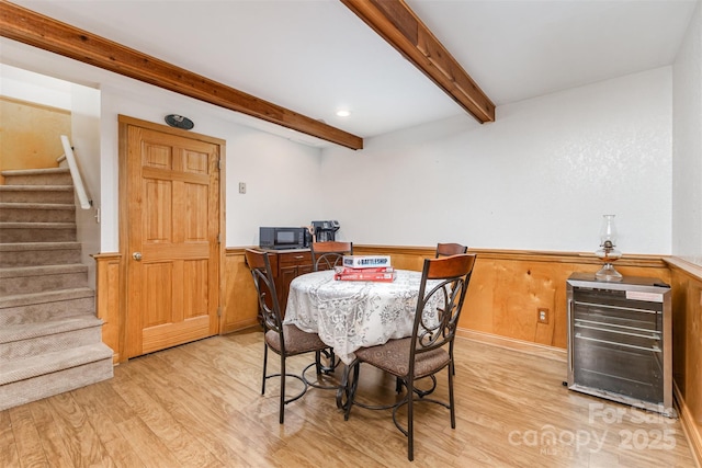3060 Texs Fish Camp Rd, Connelly Springs, NC 28612 - dining area with light wood-style flooring, beam ceiling, wainscoting, stairs, and beverage cooler