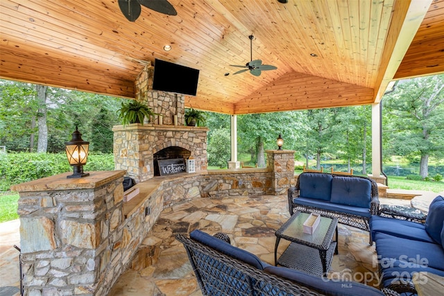 3060 Texs Fish Camp Rd, Connelly Springs, NC 28612 - view of patio with a ceiling fan, an outdoor living space with a fireplace, and view of scattered trees