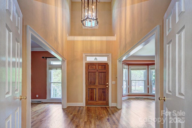 8044 Hawk Crest Ct, Charlotte, NC 28270 - entrance foyer featuring a high ceiling, wood finished floors, and a chandelier