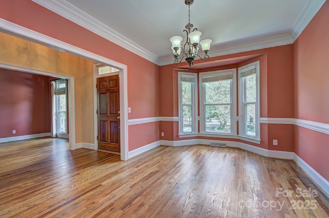 8044 Hawk Crest Ct, Charlotte, NC 28270 - empty room featuring plenty of natural light, a chandelier, wood finished floors, and ornamental molding