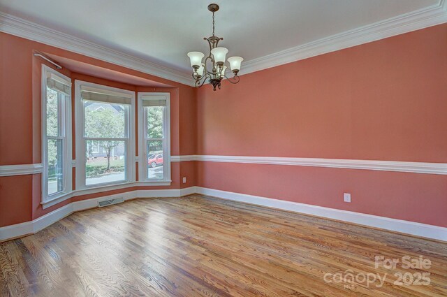 8044 Hawk Crest Ct, Charlotte, NC 28270 - empty room featuring a chandelier, wood finished floors, and ornamental molding