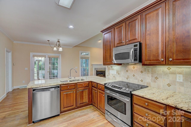 8044 Hawk Crest Ct, Charlotte, NC 28270 - kitchen with appliances with stainless steel finishes, a peninsula, light wood-type flooring, a chandelier, and crown molding
