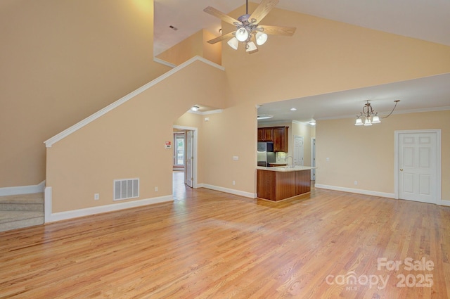 8044 Hawk Crest Ct, Charlotte, NC 28270 - unfurnished living room with a chandelier, light wood-type flooring, a ceiling fan, stairs, and high vaulted ceiling