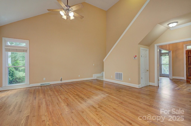 8044 Hawk Crest Ct, Charlotte, NC 28270 - unfurnished living room featuring a ceiling fan, high vaulted ceiling, light wood-style flooring, and stairs