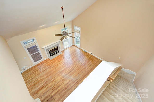8044 Hawk Crest Ct, Charlotte, NC 28270 - unfurnished living room featuring a ceiling fan, light wood finished floors, a fireplace with flush hearth, and lofted ceiling
