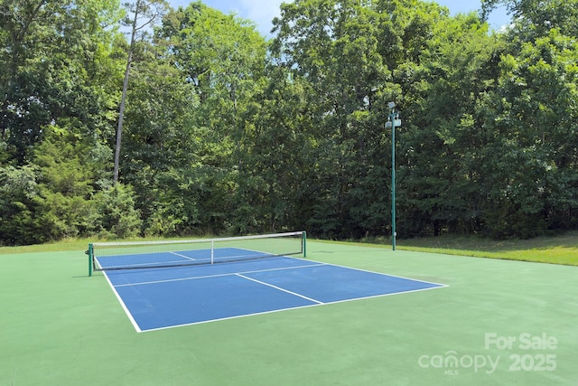 8044 Hawk Crest Ct, Charlotte, NC 28270 - view of tennis court featuring a forest view