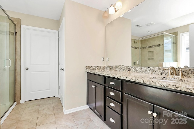 10004 Perth Moor Rd, Charlotte, NC 28278 - full bath featuring double vanity, a shower stall, tile patterned floors, and baseboards