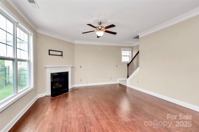 10004 Perth Moor Rd, Charlotte, NC 28278 - unfurnished living room featuring wood finished floors, ornamental molding, ceiling fan, stairway, and a fireplace