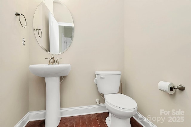 10004 Perth Moor Rd, Charlotte, NC 28278 - half bath with wood finished floors, toilet, and baseboards