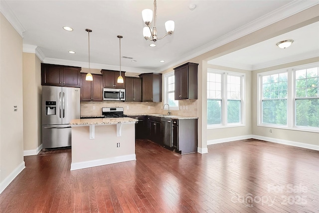 10004 Perth Moor Rd, Charlotte, NC 28278 - kitchen with appliances with stainless steel finishes, a sink, dark wood-type flooring, dark brown cabinets, and ornamental molding