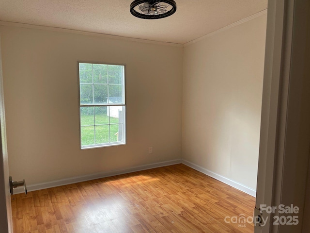 1201 Forest Ridge Rd, Bessemer City, NC 28016 - spare room featuring ornamental molding, light wood-type flooring, baseboards, and a textured ceiling