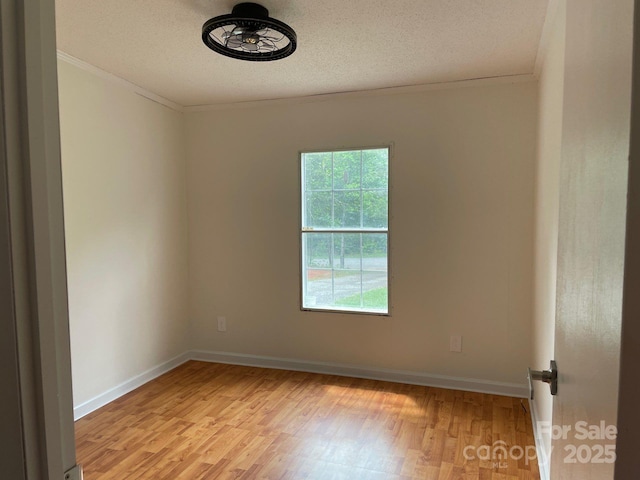 1201 Forest Ridge Rd, Bessemer City, NC 28016 - empty room featuring light wood-style floors, ornamental molding, baseboards, and a textured ceiling