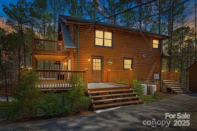 447 Hidden Lake Pkwy, Nebo, NC 28761 - view of front of house with a balcony, central AC, a deck, and log exterior