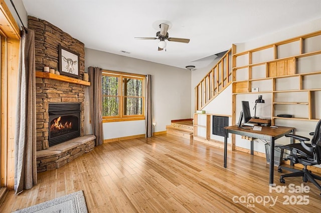 447 Hidden Lake Pkwy, Nebo, NC 28761 - office area with light wood-type flooring, a stone fireplace, a ceiling fan, and baseboards