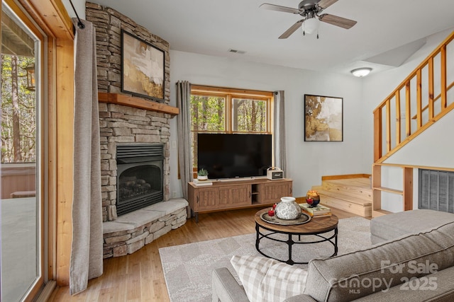 447 Hidden Lake Pkwy, Nebo, NC 28761 - living area featuring hardwood / wood-style floors, a fireplace, a ceiling fan, and stairway