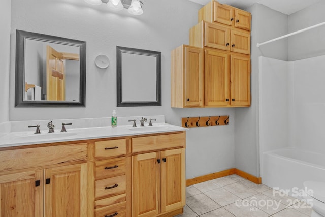 447 Hidden Lake Pkwy, Nebo, NC 28761 - bathroom with tile patterned floors, double vanity, toilet,  shower combination, and baseboards