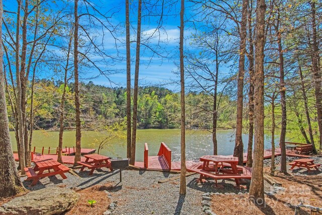 447 Hidden Lake Pkwy, Nebo, NC 28761 - view of yard with a boat dock, a wooded view, and a water view