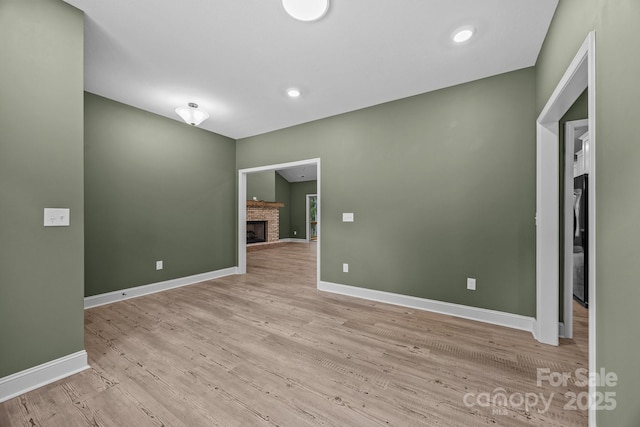 140 Cove Crest Dr, Rutherfordton, NC 28139 - unfurnished room featuring a brick fireplace, light wood-type flooring, and baseboards