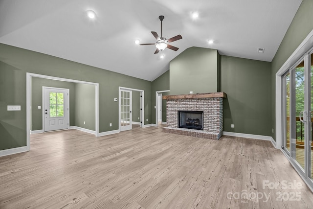 140 Cove Crest Dr, Rutherfordton, NC 28139 - unfurnished living room with a ceiling fan, lofted ceiling, a fireplace, light wood finished floors, and plenty of natural light