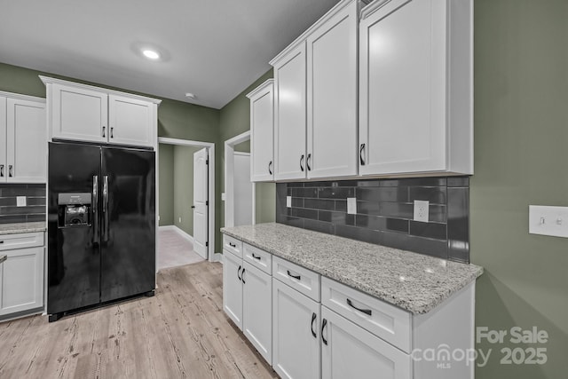 140 Cove Crest Dr, Rutherfordton, NC 28139 - kitchen featuring black refrigerator with ice dispenser, light wood-style floors, decorative backsplash, and white cabinetry