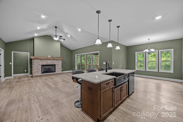140 Cove Crest Dr, Rutherfordton, NC 28139 - kitchen featuring a sink, light wood-type flooring, a brick fireplace, hanging light fixtures, and ceiling fan