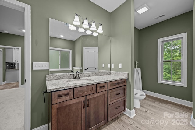 140 Cove Crest Dr, Rutherfordton, NC 28139 - bathroom featuring toilet, vanity, wood finished floors, and baseboards