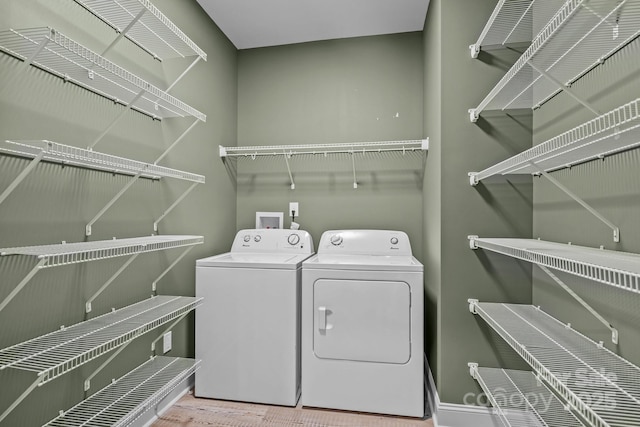 140 Cove Crest Dr, Rutherfordton, NC 28139 - washroom featuring separate washer and dryer, baseboards, and wood finished floors