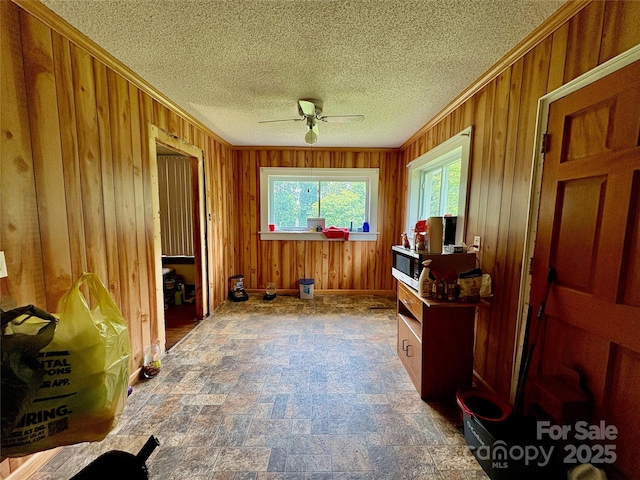 78 Moffitt Hill Church Rd, Old Fort, NC 28762 - office area with ceiling fan, wooden walls, stone finish floors, ornamental molding, and a textured ceiling