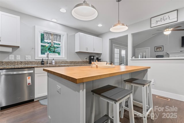 6313 Weddington Rd, Concord, NC 28027 - kitchen featuring dishwasher, butcher block countertops, a breakfast bar, white cabinetry, and recessed lighting