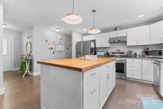 6313 Weddington Rd, Concord, NC 28027 - kitchen featuring appliances with stainless steel finishes, under cabinet range hood, wooden counters, white cabinetry, and recessed lighting