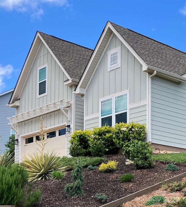 15250 Windward Ln, Lancaster, SC 29720 - view of front of home featuring board and batten siding, a shingled roof, and a garage