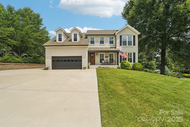 207 Spaniel Dr SE, Concord, NC 28025 - view of front of house with covered porch, driveway, a front yard, a garage, and a shingled roof