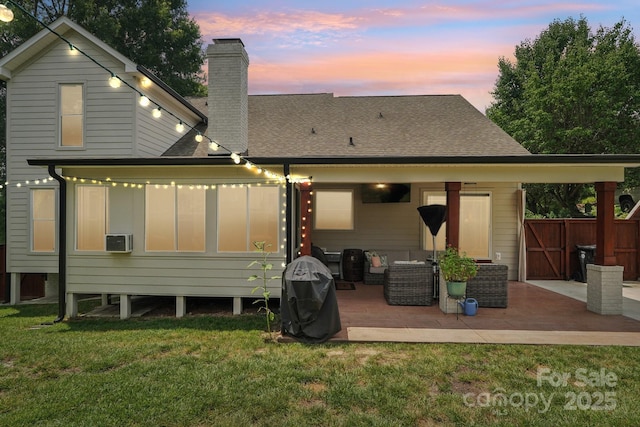 207 Spaniel Dr SE, Concord, NC 28025 - back of property with a patio, a chimney, a yard, and a shingled roof