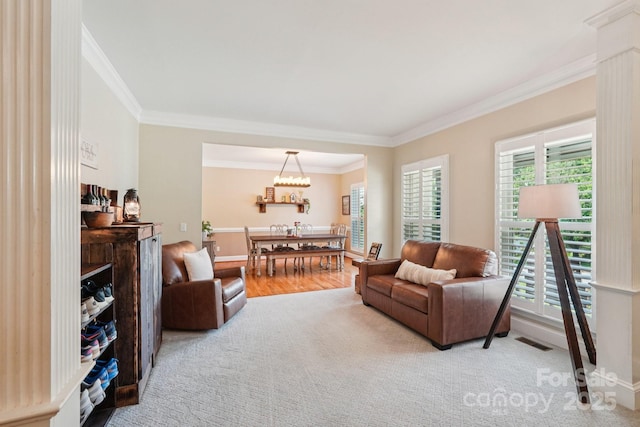 207 Spaniel Dr SE, Concord, NC 28025 - living room featuring ornamental molding, a chandelier, and wood finished floors