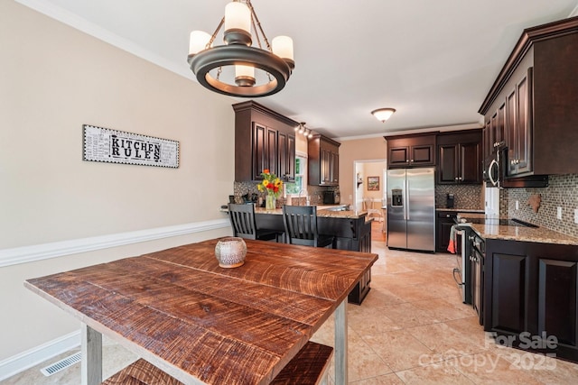 207 Spaniel Dr SE, Concord, NC 28025 - dining room featuring a chandelier, crown molding, and light tile patterned floors