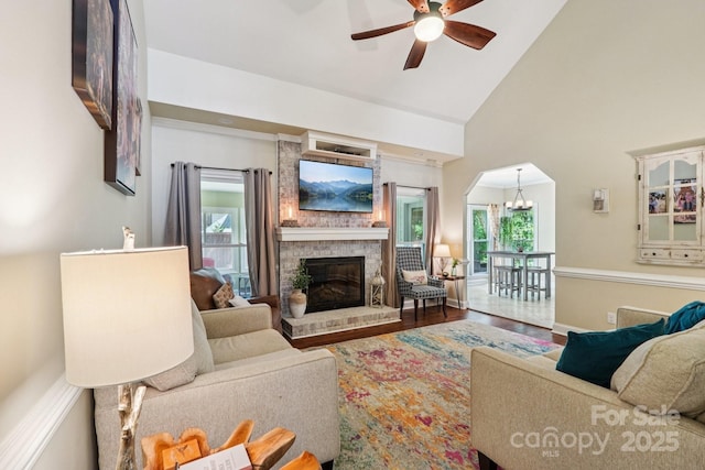 207 Spaniel Dr SE, Concord, NC 28025 - living room featuring ceiling fan, healthy amount of natural light, a fireplace, high vaulted ceiling, and wood finished floors