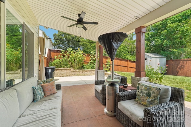 207 Spaniel Dr SE, Concord, NC 28025 - fenced backyard featuring a patio, ceiling fan, a storage unit, and an outdoor hangout area