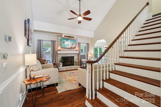 207 Spaniel Dr SE, Concord, NC 28025 - living area featuring a ceiling fan, dark wood-style floors, a brick fireplace, stairway, and high vaulted ceiling