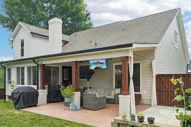 207 Spaniel Dr SE, Concord, NC 28025 - back of property with a patio, a chimney, roof with shingles, an outdoor hangout area, and a gate
