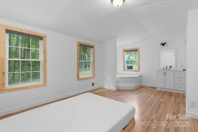 8692 Lambs Way, Connelly Springs, NC 28612 - bedroom featuring lofted ceiling, light wood-style floors, multiple windows, baseboards, and a sink