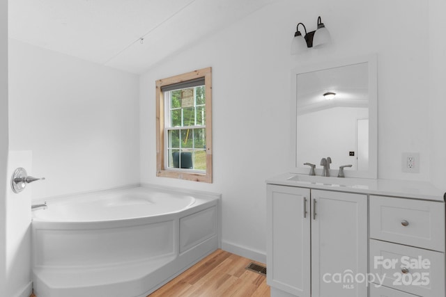 8692 Lambs Way, Connelly Springs, NC 28612 - bathroom featuring vanity, wood finished floors, a garden tub, and lofted ceiling