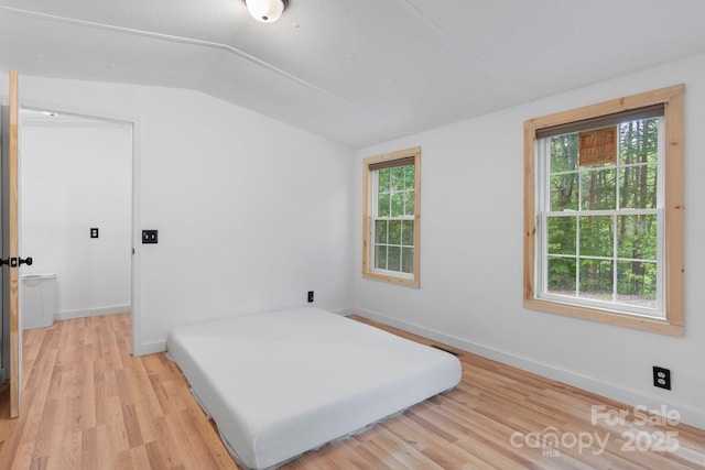 8692 Lambs Way, Connelly Springs, NC 28612 - bedroom featuring vaulted ceiling, light wood-style flooring, and baseboards