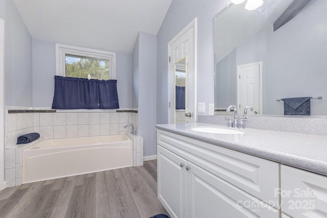 147 Buck And Doe Ln, Statesville, NC 28625 - full bathroom with vaulted ceiling, vanity, wood finished floors, and a garden tub