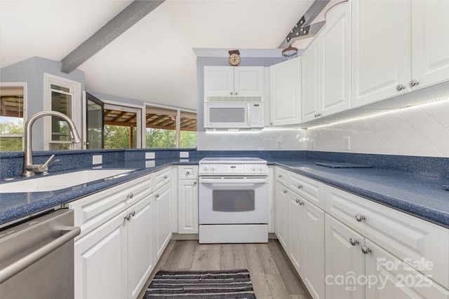147 Buck And Doe Ln, Statesville, NC 28625 - kitchen with white appliances, a sink, dark countertops, light wood-style floors, and plenty of natural light