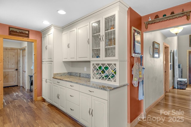 333 Lambs Grill Rd, Rutherfordton, NC 28139 - kitchen featuring light wood-type flooring, white cabinetry, baseboards, glass insert cabinets, and recessed lighting