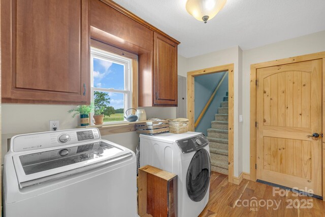 333 Lambs Grill Rd, Rutherfordton, NC 28139 - laundry room with independent washer and dryer, cabinet space, and light wood finished floors