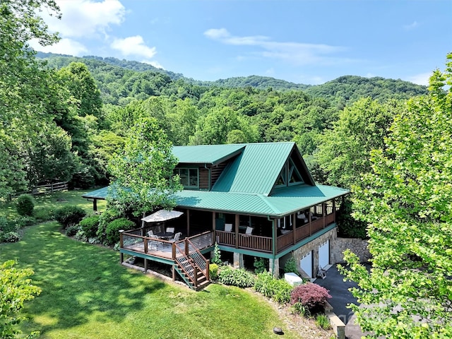32 Tibi Ln, Waynesville, NC 28785 - back of house with a view of trees, an attached garage, a yard, stone siding, and metal roof